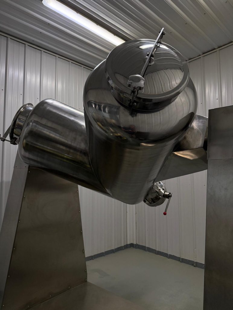 Twin-shell V-blender on its stand in the production room